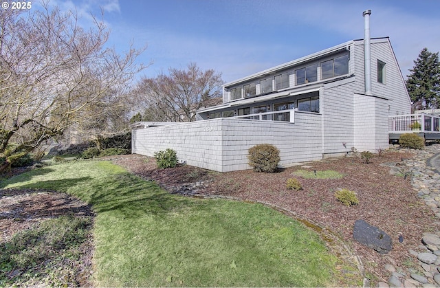 rear view of house featuring a yard