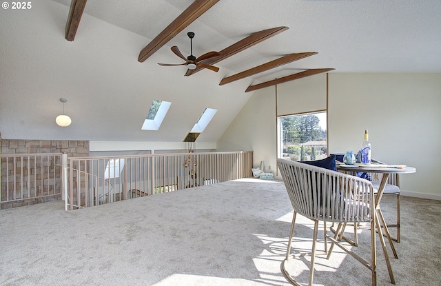 interior space featuring vaulted ceiling with skylight and ceiling fan