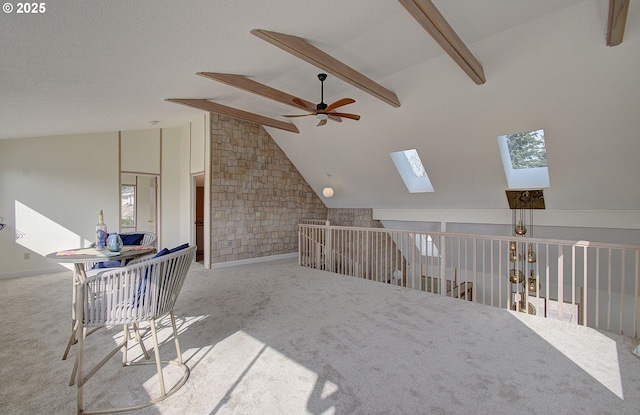 interior space featuring vaulted ceiling with beams, baseboards, and carpet floors