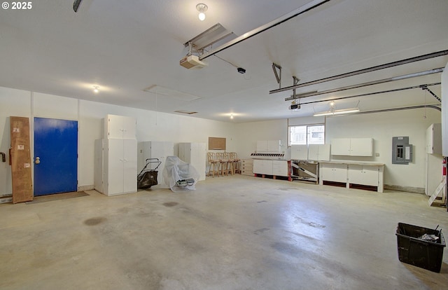 garage featuring electric panel and a garage door opener