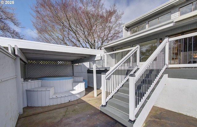 exterior space featuring a jacuzzi, a patio area, and stairway