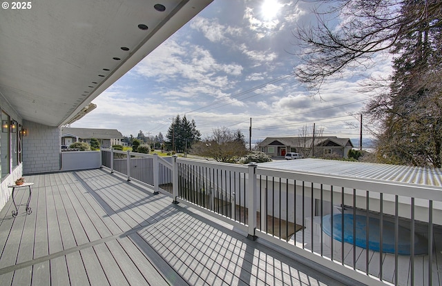 deck with a pool and a residential view