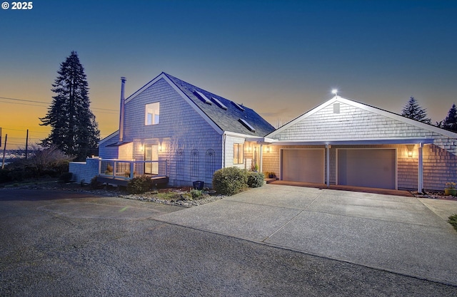 view of front of property with concrete driveway and an attached garage