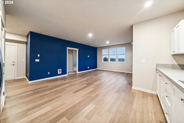 unfurnished living room featuring light wood-type flooring