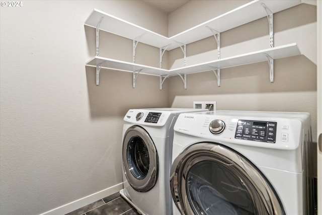 clothes washing area with separate washer and dryer and dark tile patterned floors