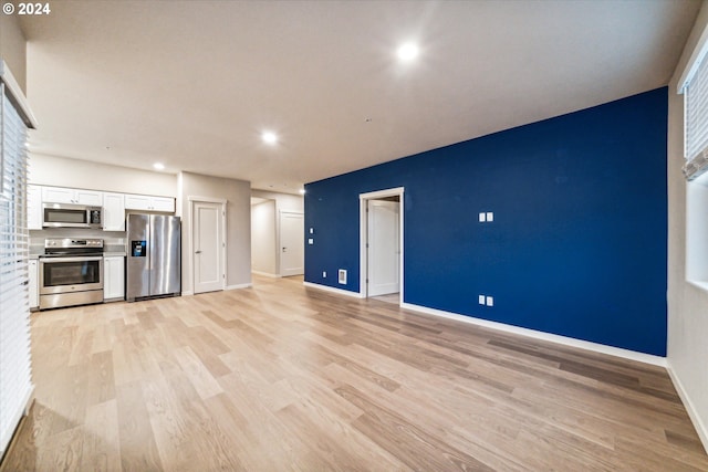 unfurnished living room featuring light wood-type flooring