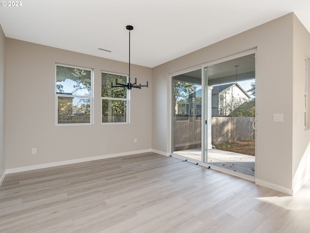 unfurnished dining area with light hardwood / wood-style flooring and a healthy amount of sunlight