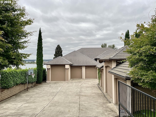 view of front facade with a water view and a garage