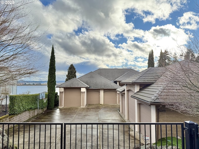 view of front of house with a water view and a garage