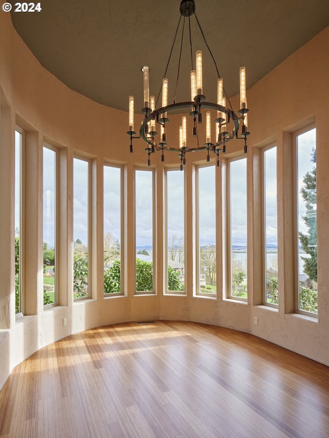 unfurnished sunroom featuring an inviting chandelier