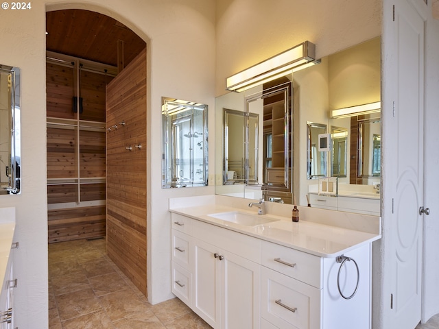 bathroom featuring wooden walls and vanity