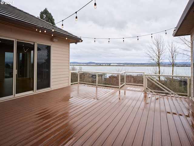 wooden terrace featuring a water view