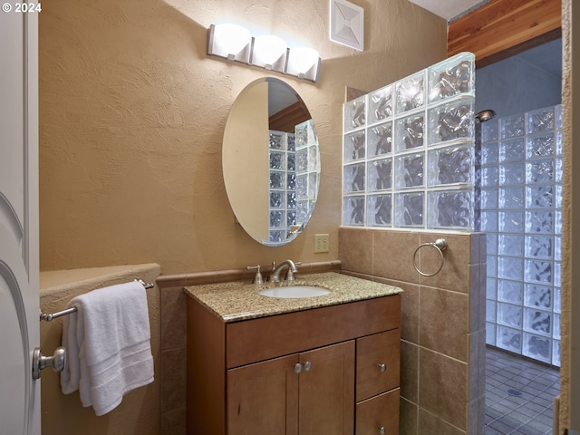 bathroom with vanity, a shower, and tile patterned floors