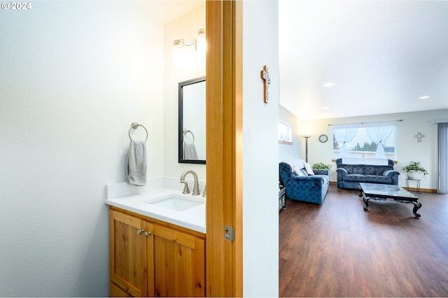 bathroom with hardwood / wood-style floors and vanity