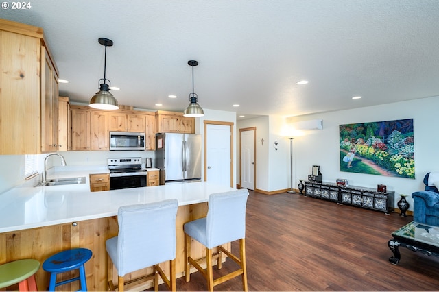 kitchen with sink, hanging light fixtures, dark hardwood / wood-style flooring, kitchen peninsula, and stainless steel appliances