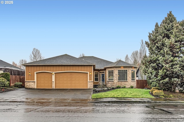 view of front of home featuring a garage, stone siding, fence, and driveway