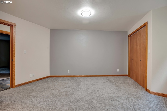 additional living space featuring lofted ceiling and light colored carpet