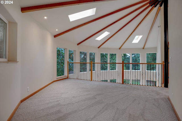 unfurnished bedroom featuring lofted ceiling with beams, carpet flooring, and multiple windows