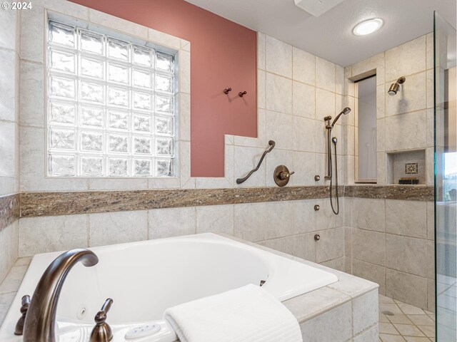 bathroom featuring separate shower and tub