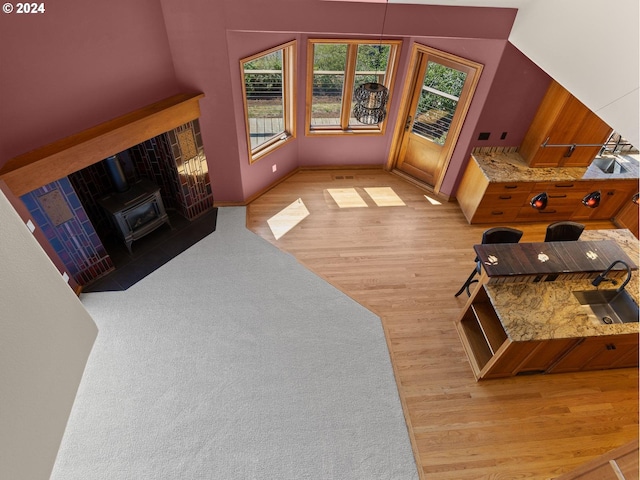 living room with light wood-type flooring and a wood stove