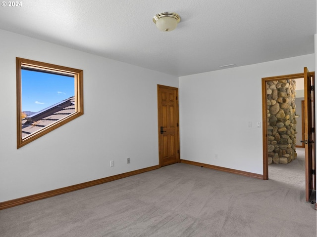 empty room featuring light carpet