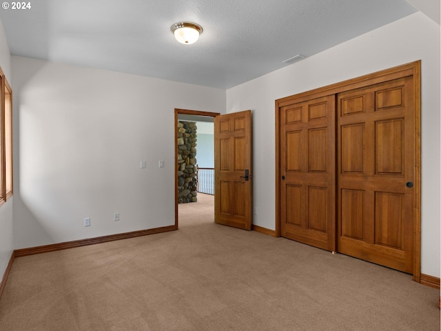 unfurnished bedroom with light colored carpet