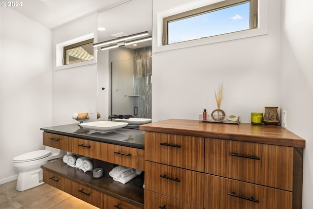 bathroom featuring vanity, toilet, and a wealth of natural light