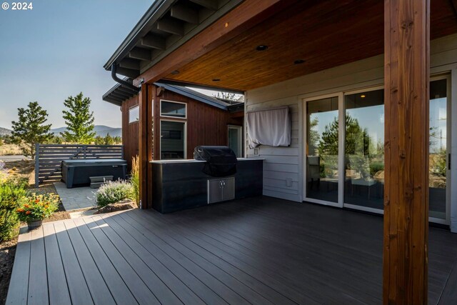 wooden deck featuring a patio, area for grilling, and a hot tub