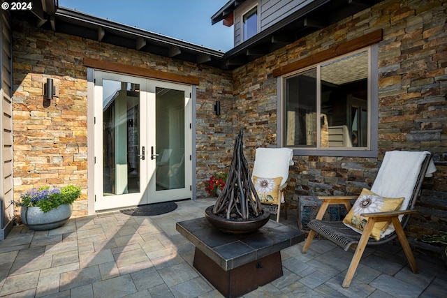 view of patio / terrace featuring an outdoor fire pit and french doors