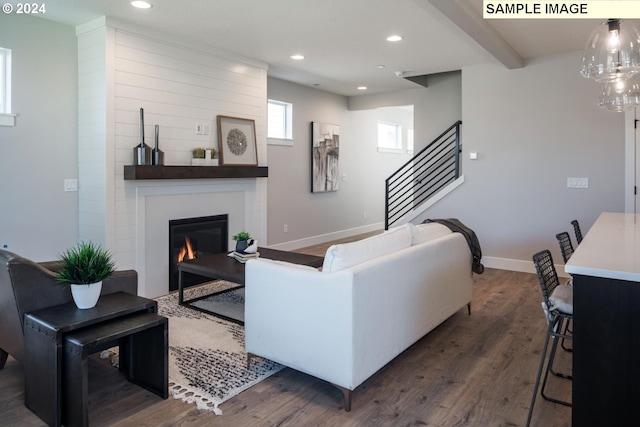 living room featuring beam ceiling and dark hardwood / wood-style floors