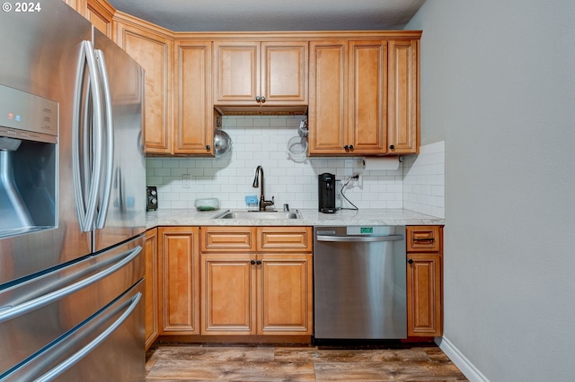 kitchen featuring dark hardwood / wood-style floors, backsplash, sink, and stainless steel appliances