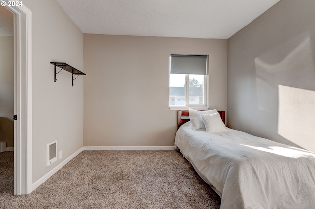 bedroom with a textured ceiling and carpet