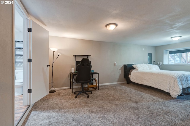 carpeted bedroom featuring a textured ceiling