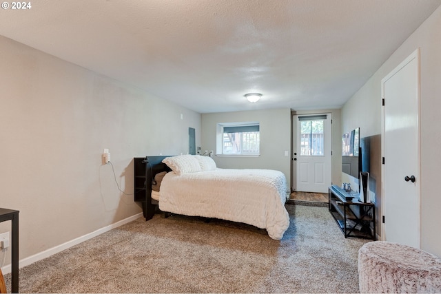 bedroom with a textured ceiling and carpet floors