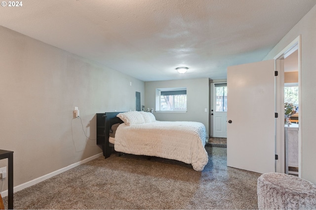 carpeted bedroom with a textured ceiling