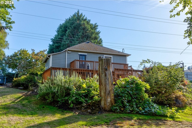 exterior space featuring a deck and a front lawn