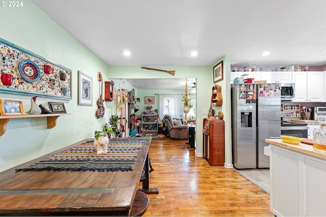 kitchen featuring stainless steel appliances, light wood-type flooring, white cabinetry, and recessed lighting