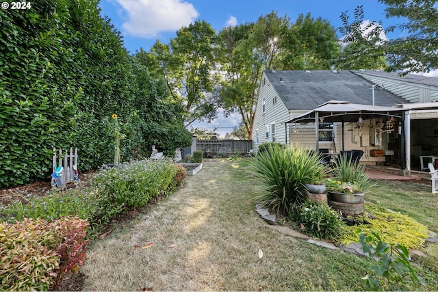 view of yard with ceiling fan and a patio area