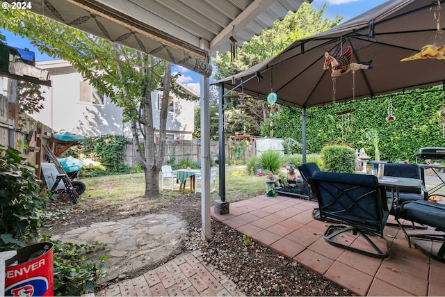 view of patio featuring a fenced backyard and a gazebo