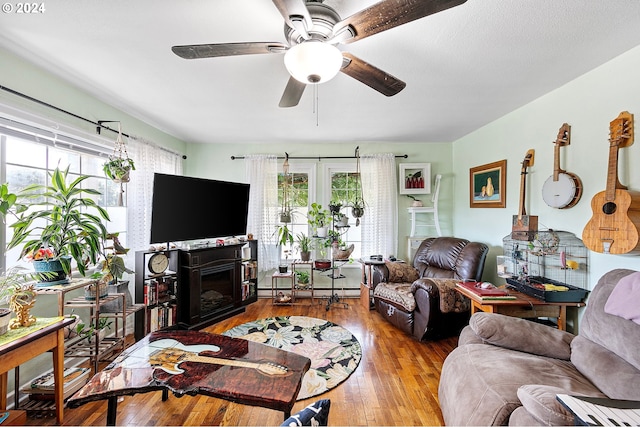 living room with hardwood / wood-style flooring, plenty of natural light, and ceiling fan