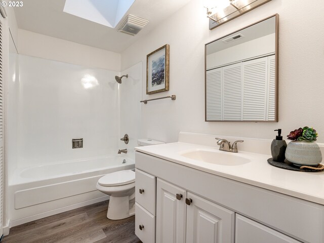 full bathroom featuring vanity, toilet, hardwood / wood-style floors, and bathing tub / shower combination