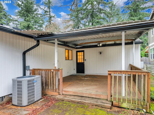 entrance to property with a wooden deck and central AC