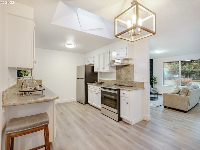 kitchen featuring light wood-type flooring, pendant lighting, stainless steel appliances, backsplash, and white cabinets