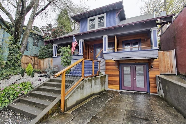 rear view of house with french doors and a balcony