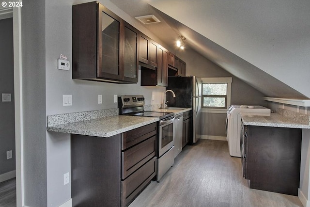 kitchen featuring light stone countertops, dark brown cabinetry, light hardwood / wood-style flooring, and stainless steel range with electric stovetop