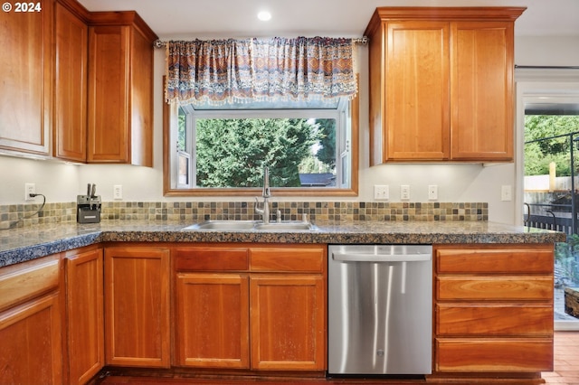 kitchen featuring light hardwood / wood-style floors, stainless steel dishwasher, and sink