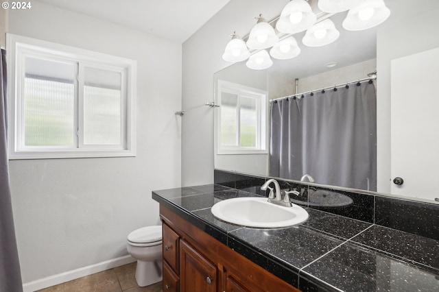 bathroom featuring toilet, vanity, and tile patterned floors