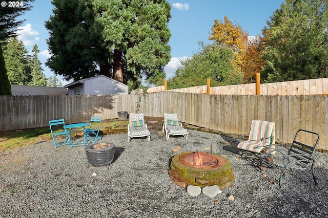 view of yard featuring a fire pit and a patio area