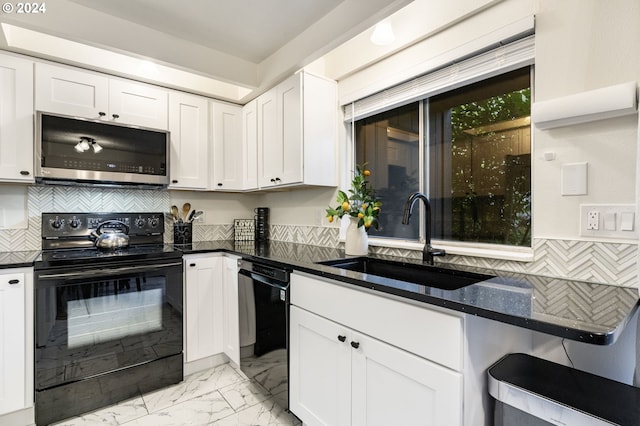 kitchen featuring dark stone countertops, sink, decorative backsplash, white cabinets, and black appliances