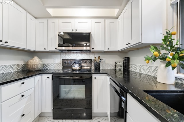 kitchen featuring dark stone counters, white cabinets, and black appliances